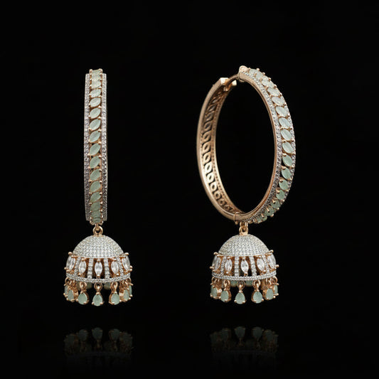 Rose gold and green gemstone earrings on a black stand with HP logo in the background