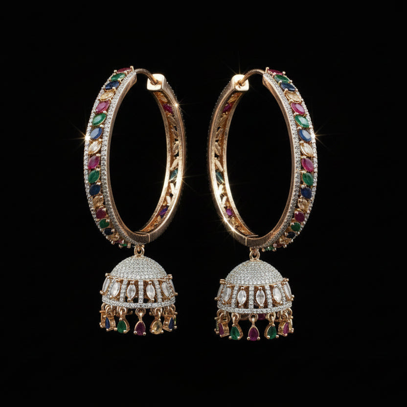 Pair of ornate earrings with gemstones on a black stand against a gray background