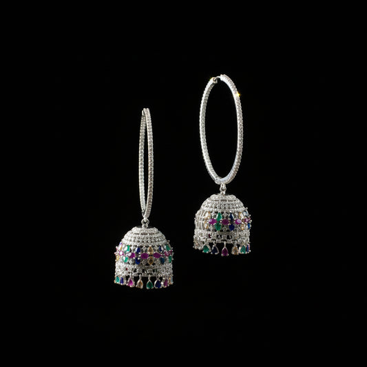 Silver earrings with gemstones on a black stand with HP logo in the background
