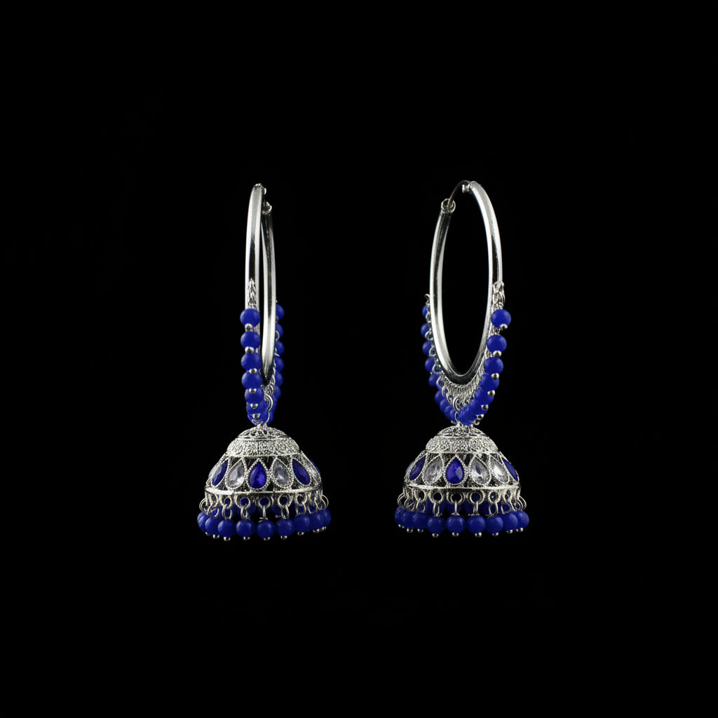 Pair of hoop earrings with blue beads on a black background