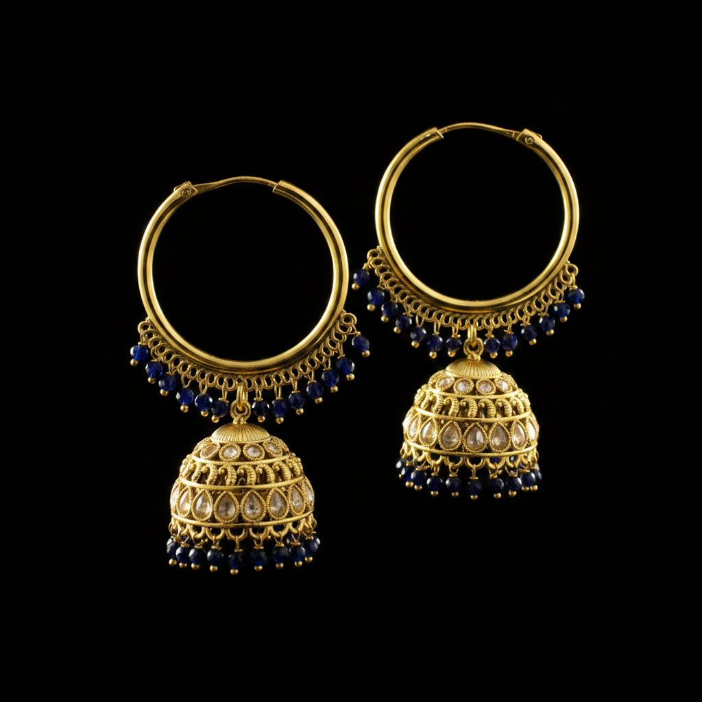 Gold hoop earrings with blue beads and decorative elements on a black background