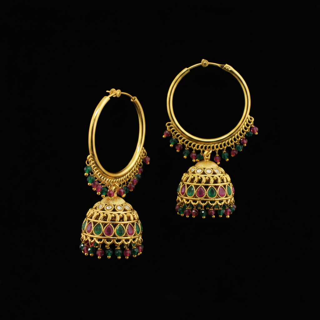 Gold hoop earrings with colorful beads on a gray background