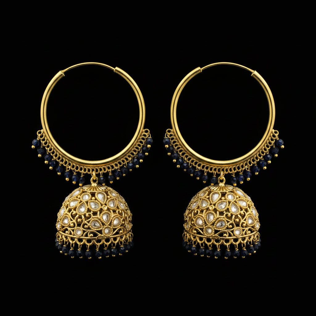 Gold hoop earrings with black beads on a gray background