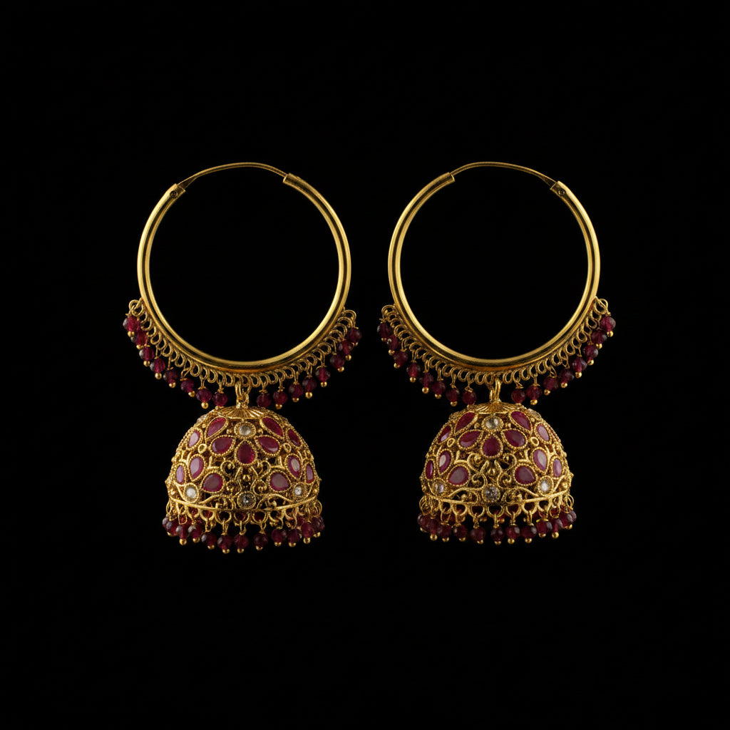 Gold hoop earrings with red gemstones on black earring stands against an HP branded background.