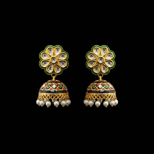 Ornate gold and green earrings with pearl accents on a gray background, featuring the brand 'SAHELI'.