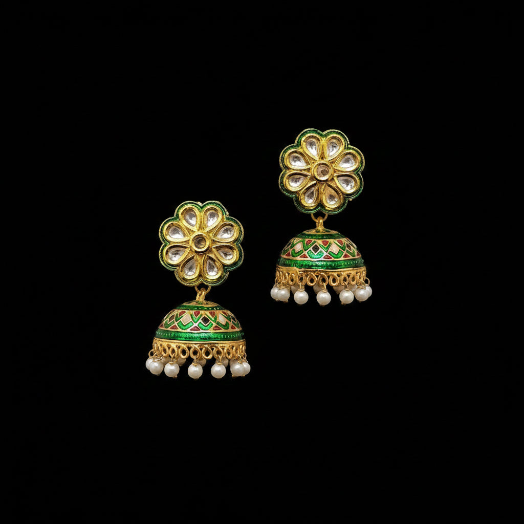 Gold and green floral earrings with pearl accents on a gray background, branded 'SAHELI'.
