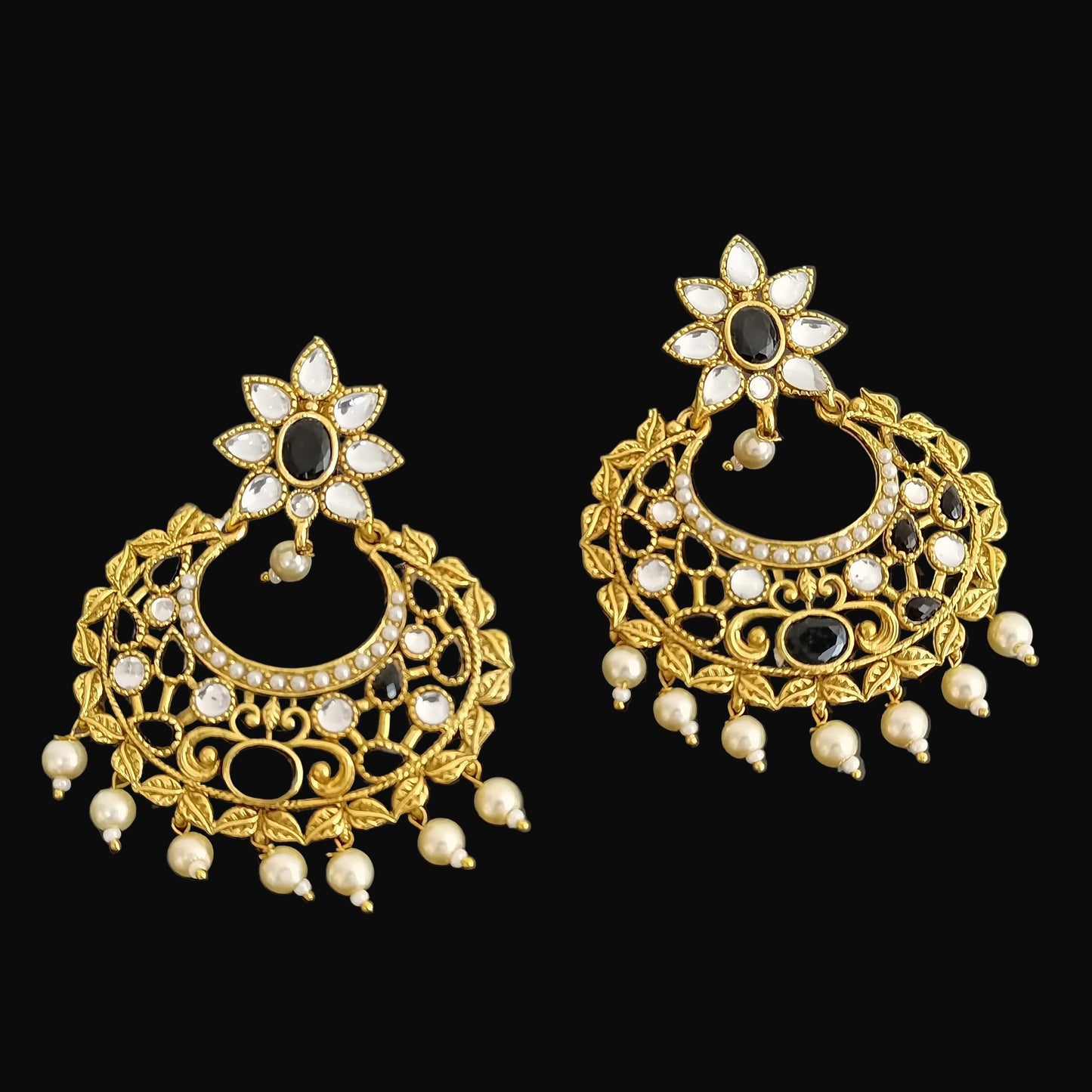 Gold and pearl earrings on a dark background with 'Saheli' branding.