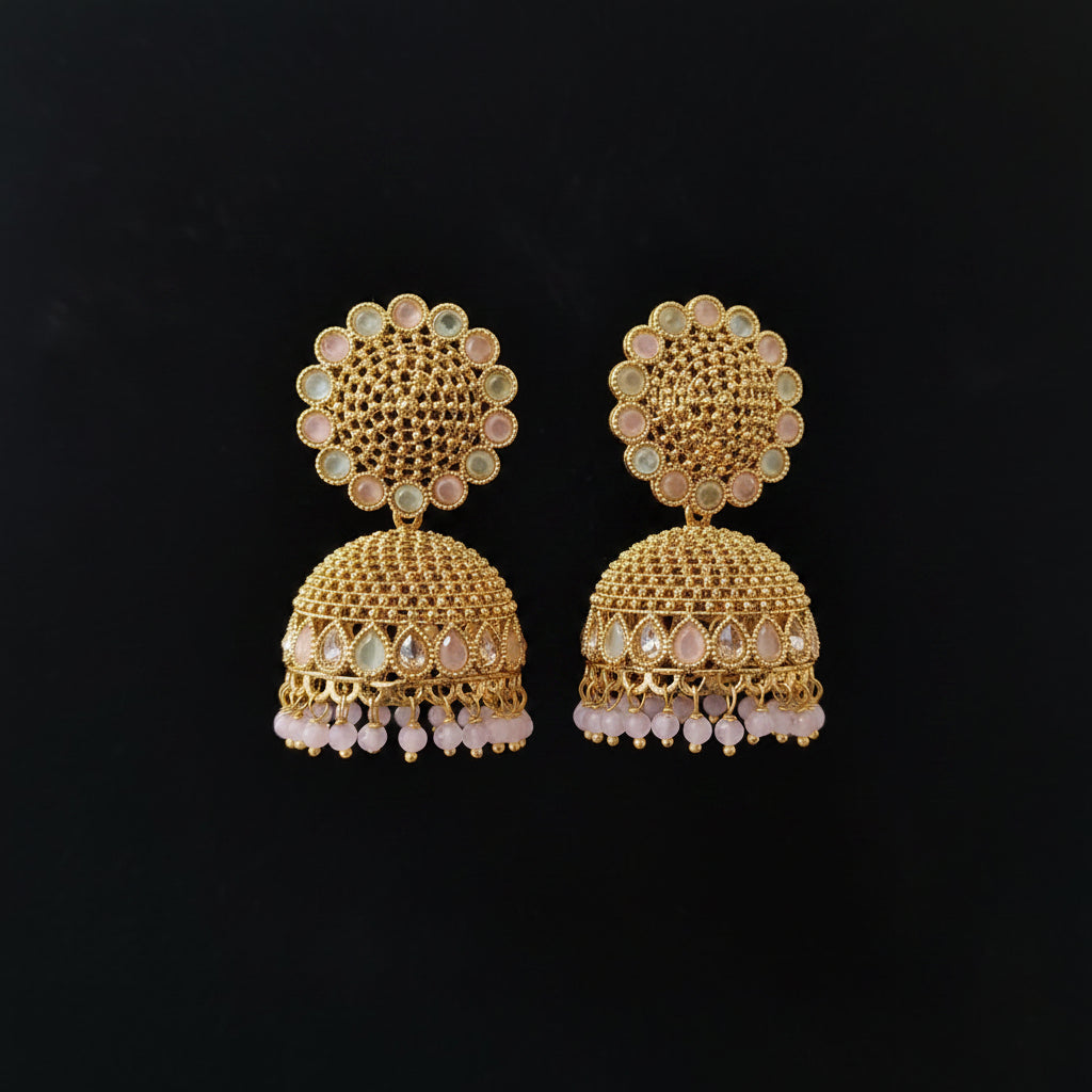 Gold earrings with intricate design on a black background