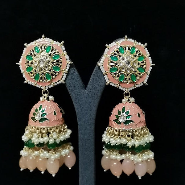 Pair of ornate earrings with pink, green, and gold colors on a black background