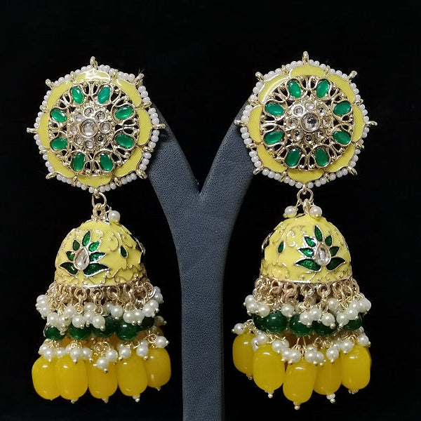Pair of yellow and green earrings on a black background