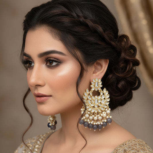 Pair of ornate earrings with gold and purple accents on a dark background, branded 'SAHELI'.
