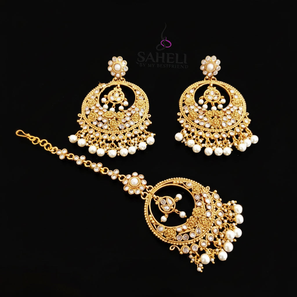 Gold jewelry set with pearls on a dark background, featuring the brand 'Saheli'.
