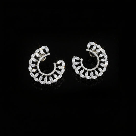 A pair of silver crescent-shaped hoop earrings adorned with clear marquise-cut crystals, displayed on a dark reflective surface with the SAHELL MY BEST FRIEND logo above them. Clear gemstones do not contribute to the color mapping, so the primary product color is Silver.