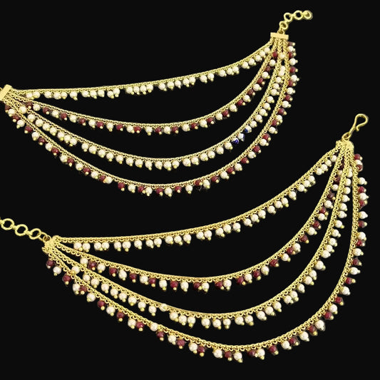 Gold chain with beads on a dark background, branded 'Saheli'.