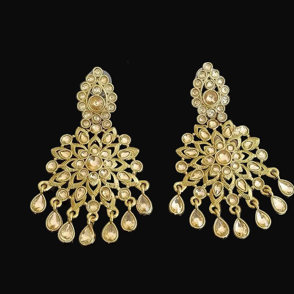 Gold earrings with intricate designs on a dark background, featuring the brand 'Saheli'.