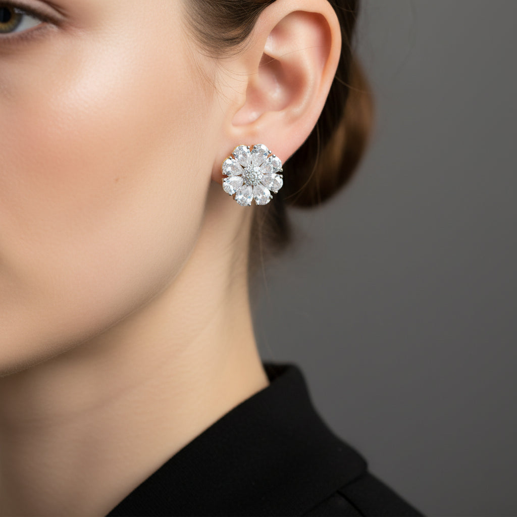 Pair of diamond earrings on a gray cushion with a dark background