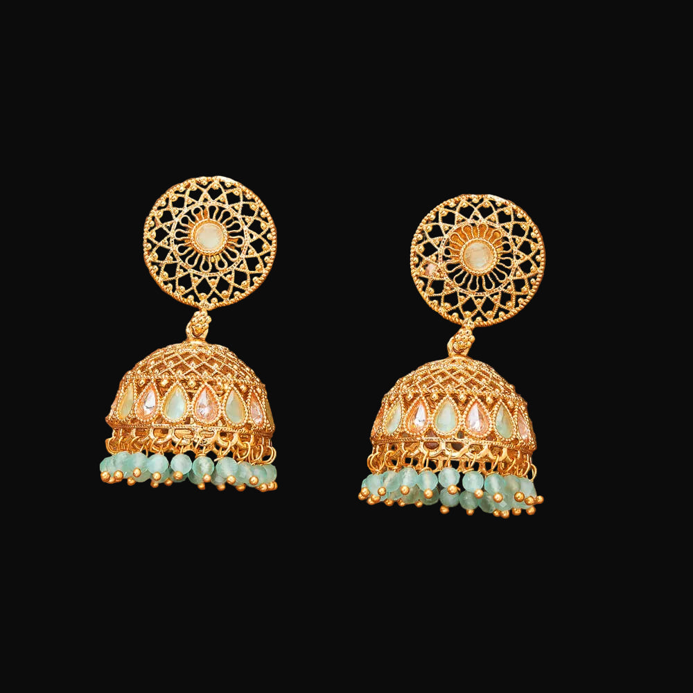 Gold and turquoise earrings on a brown background