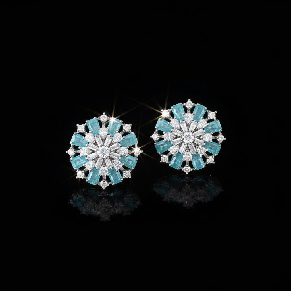 Pair of earrings with turquoise stones on a dark background