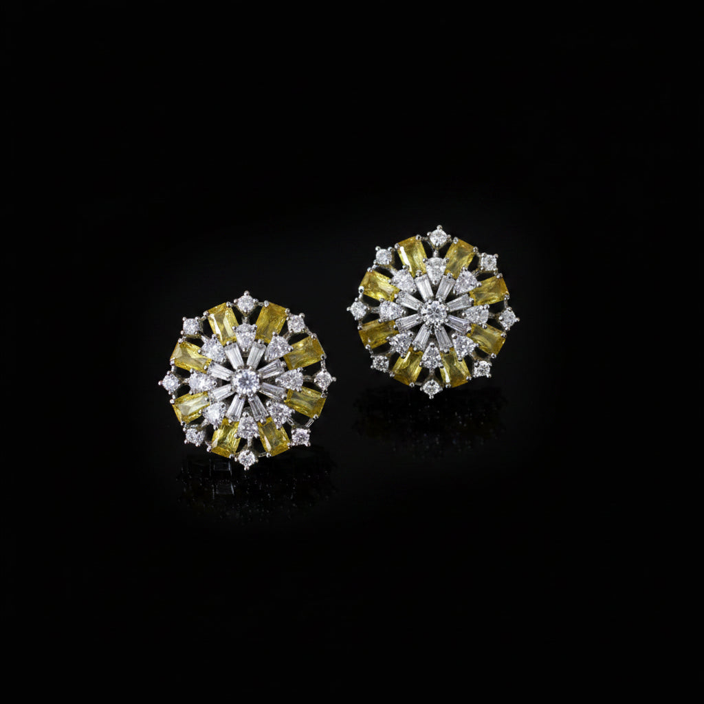 Pair of diamond earrings with yellow and white stones on a dark background