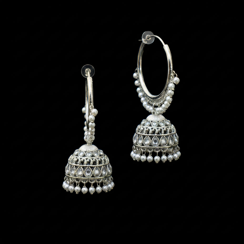 Silver hoop earrings with Jhumka designs on a black background