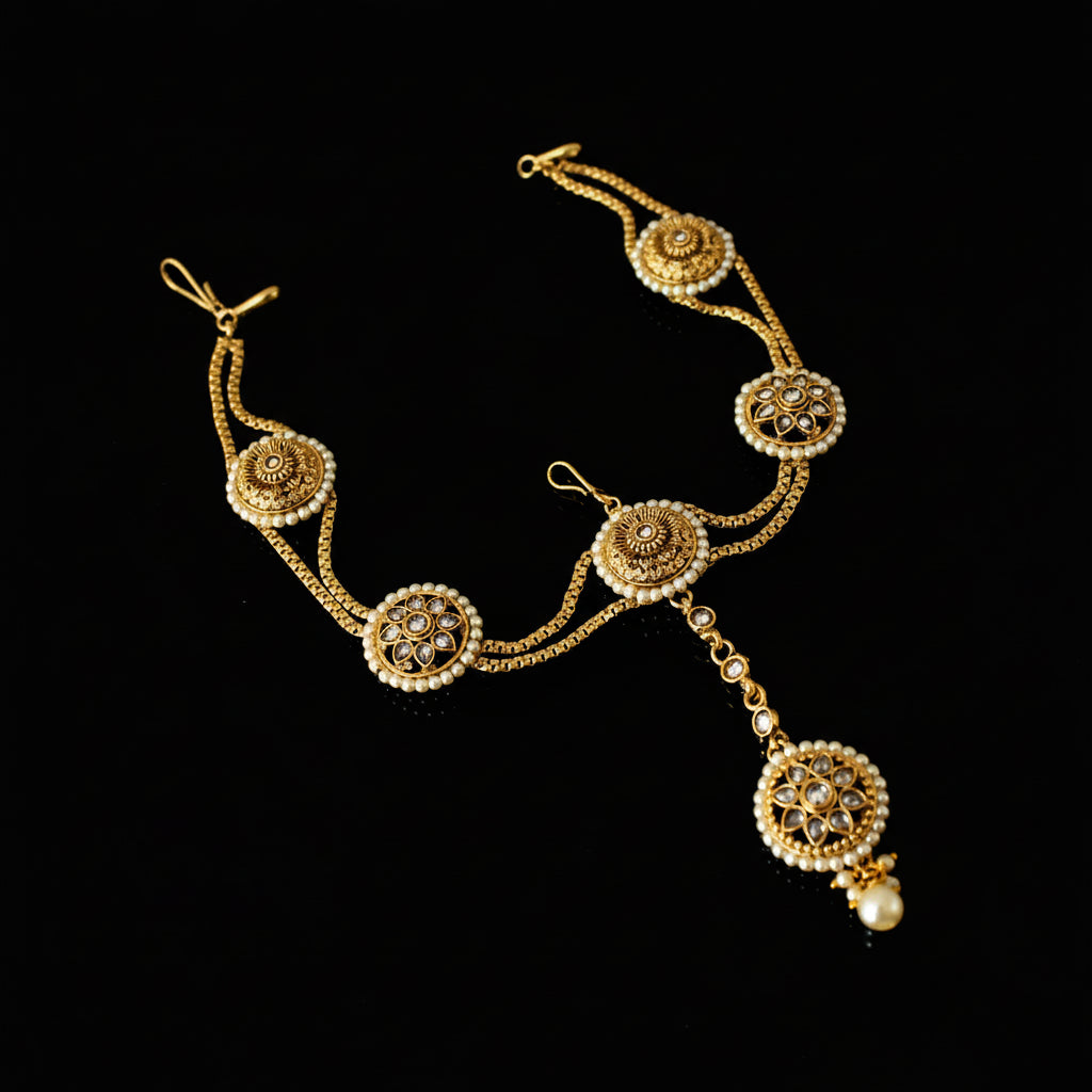Gold necklace with decorative elements on a dark background
