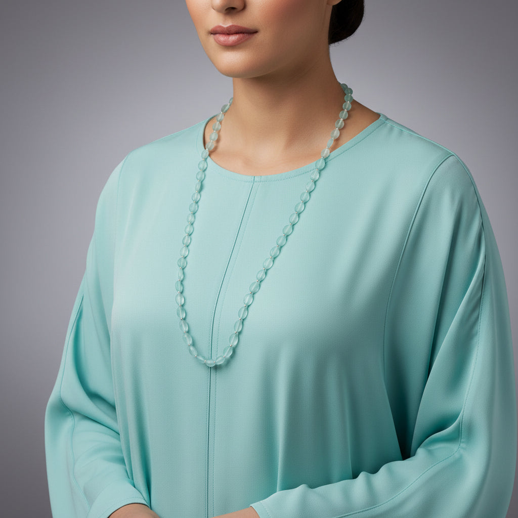 Necklace with light blue beads on a dark gray background