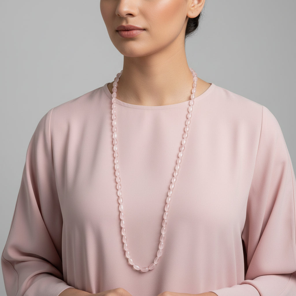 Necklace with pink beads on a dark gray background