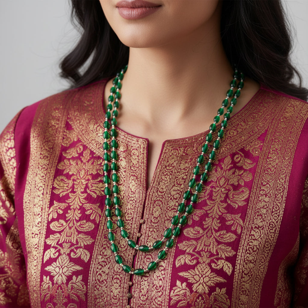 Green beaded necklace on a dark gray background