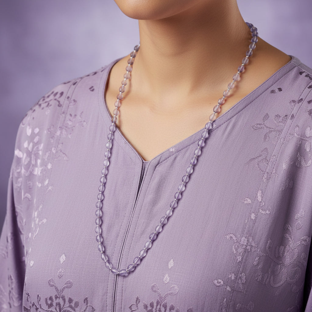 Necklace with light purple beads on a dark gray background