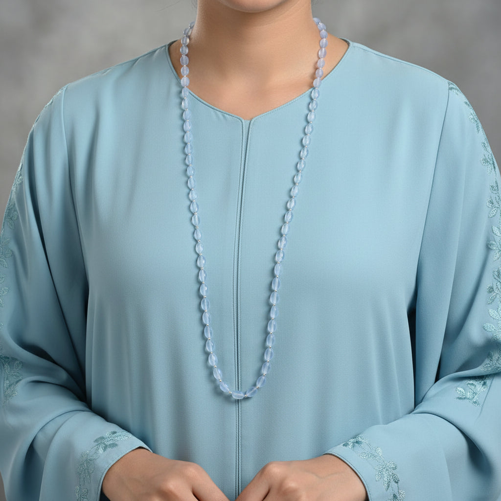 Necklace with blue beads on a dark gray background