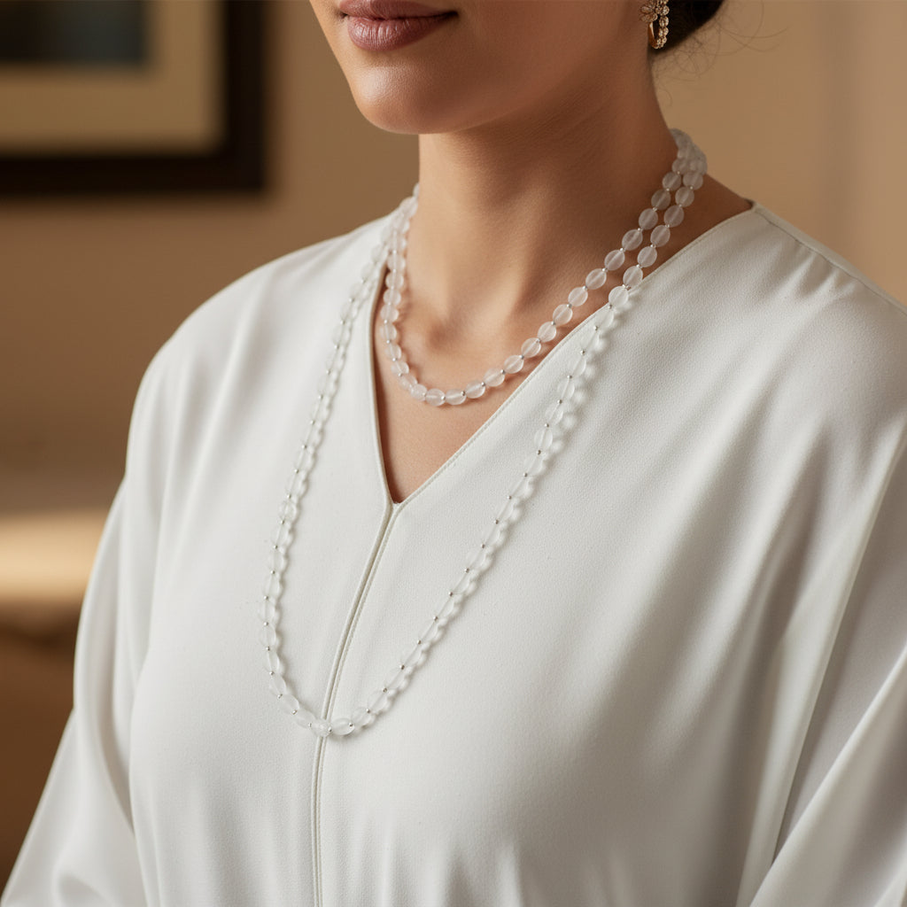 Necklace with white beads on a dark gray background
