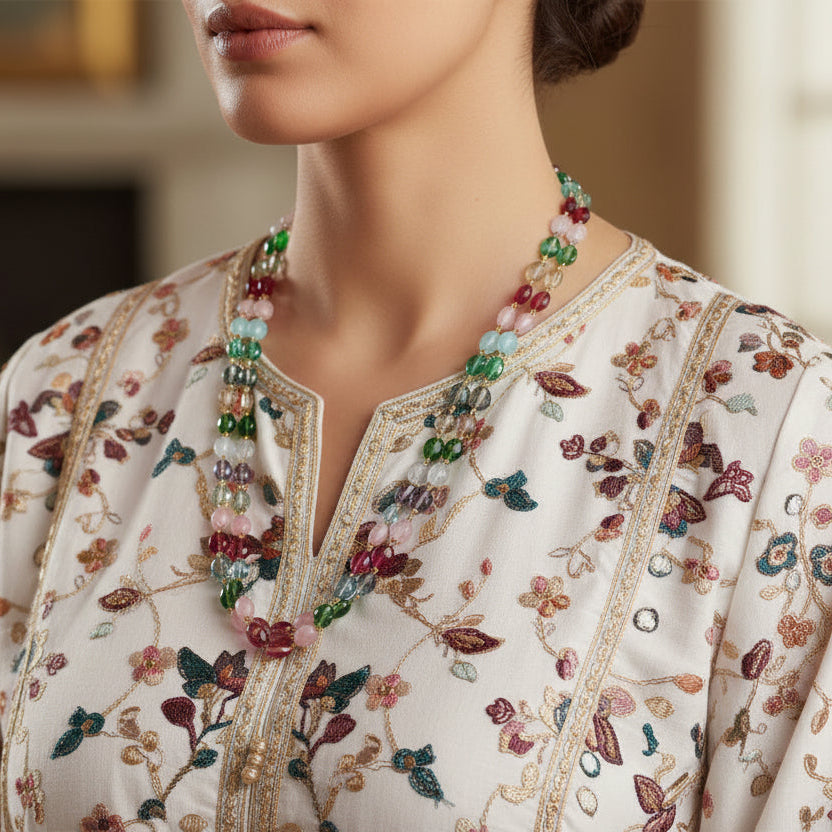Woman wearing a traditional embroidered outfit with a blurred background