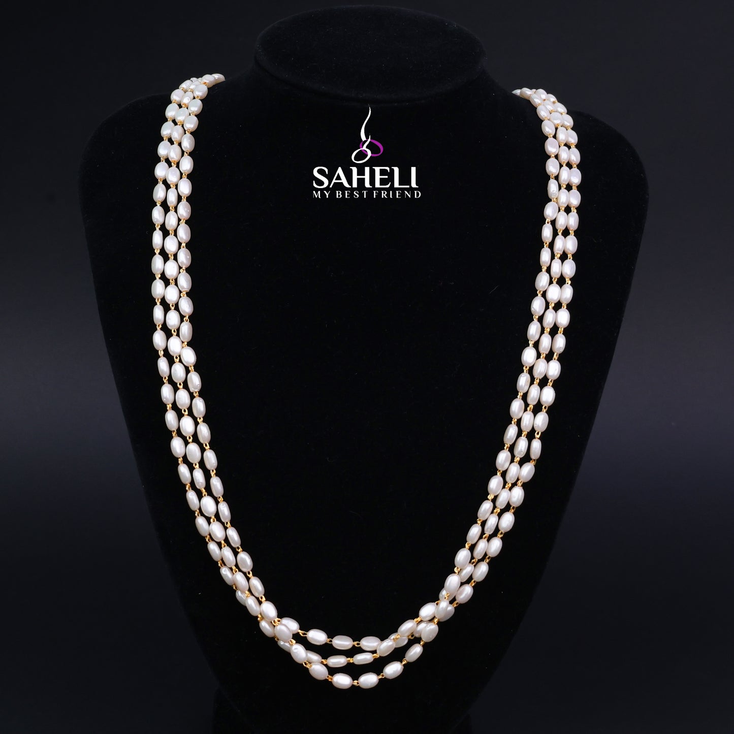 Pearl necklace on a black mannequin with 'SAHELI' branding.