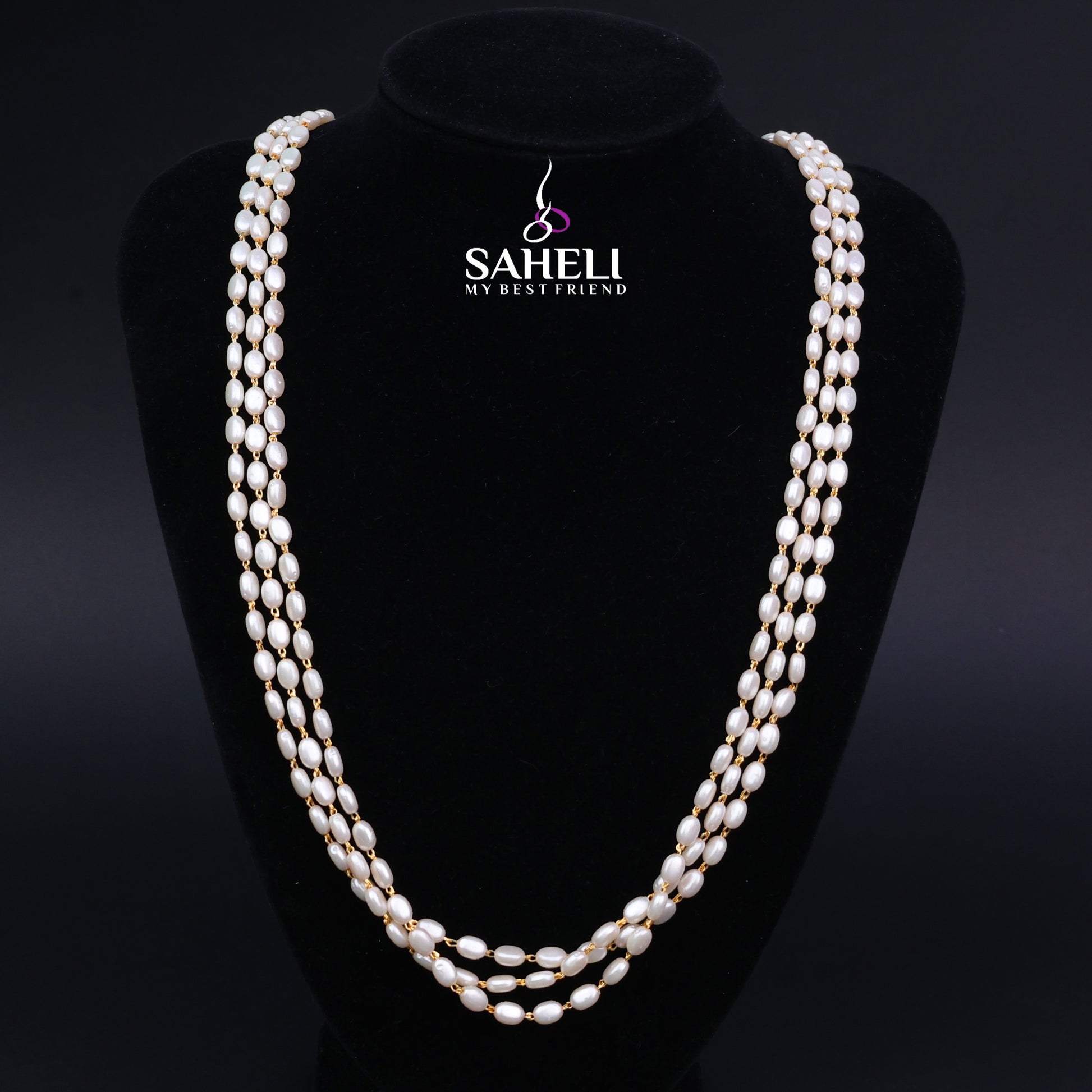 Pearl necklace on a black mannequin with 'SAHELI' branding.