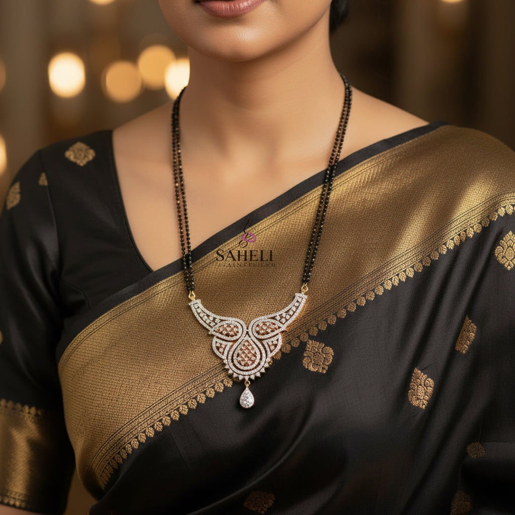 Gold and white stone jewelry set featuring a necklace with a crescent-shaped pendant and matching drop earrings, displayed on a dark background with the SAHELI brand logo.