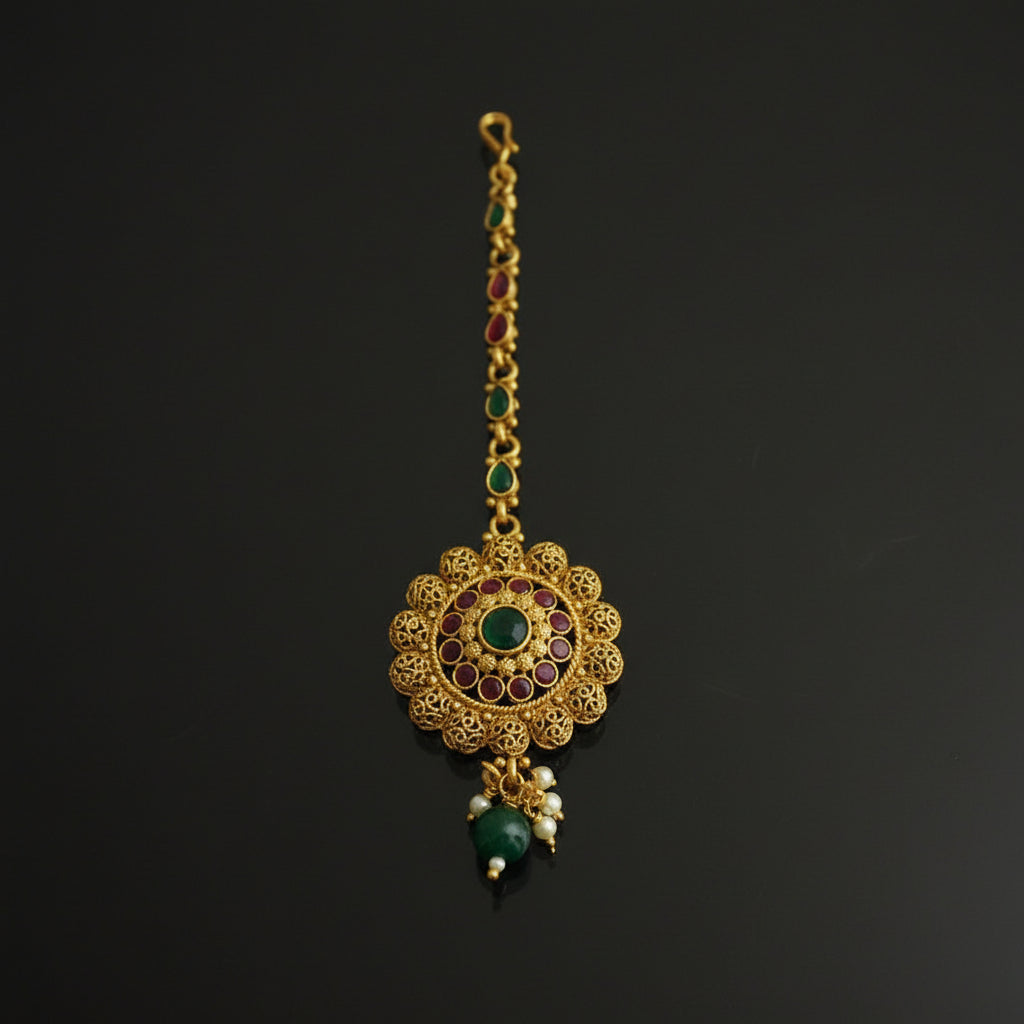 Gold necklace with green gemstones on a black background
