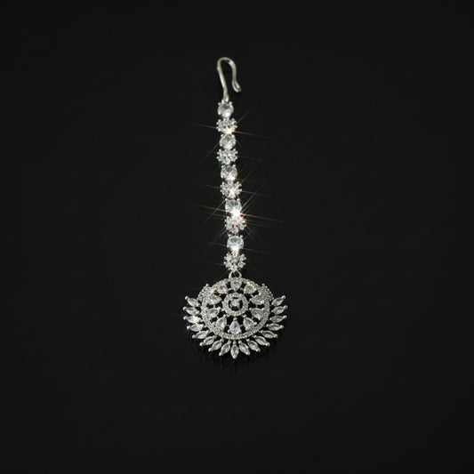 Decorative silver pendant on a black background