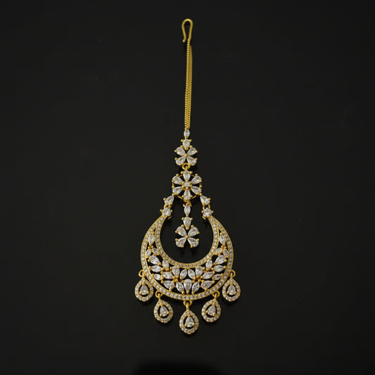 Gold decorative hairpin with intricate designs on a black background