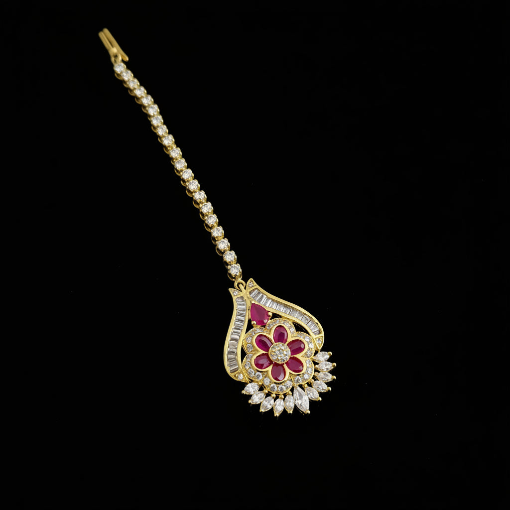 Gold necklace with a floral pendant on a dark background, featuring the brand 'SAHELI'.