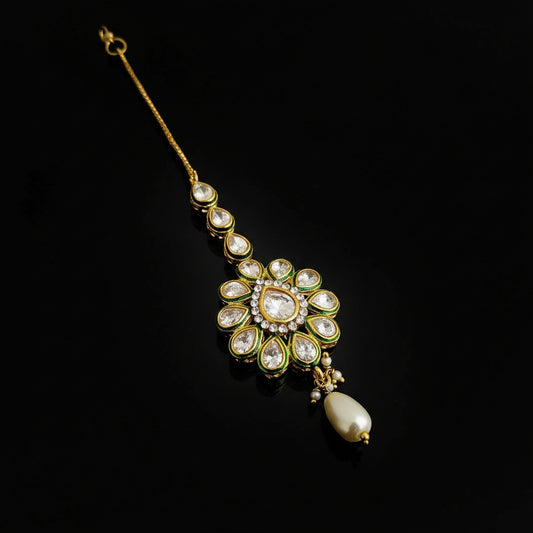 Decorative hairpin with gemstones on a dark background, featuring the brand 'SAHELI'.