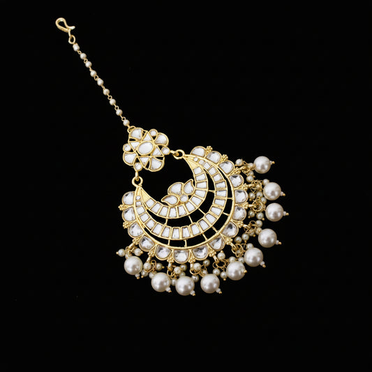 Decorative pearl necklace with gold accents on a dark background