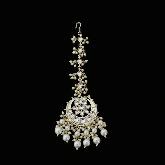 Decorative pearl necklace with gold accents on a dark background
