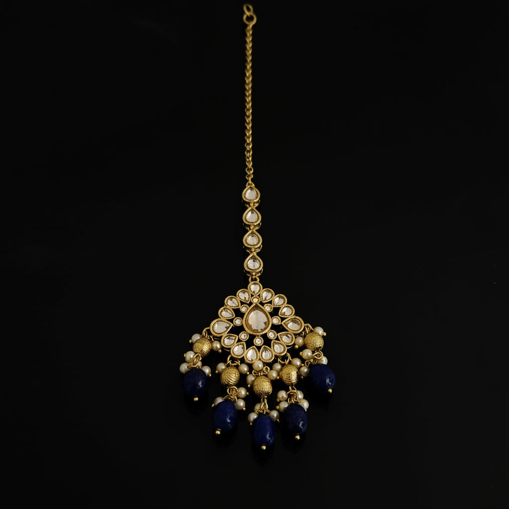 Gold and blue pendant on a black background