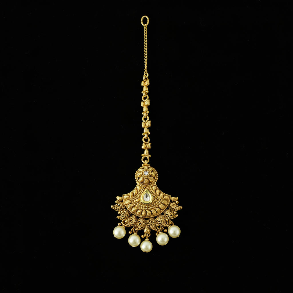 Gold necklace with pearl pendants on a gray background, featuring the brand 'Saheli'.