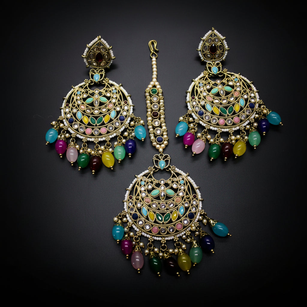 Ornate earrings with colorful gemstones on a dark background