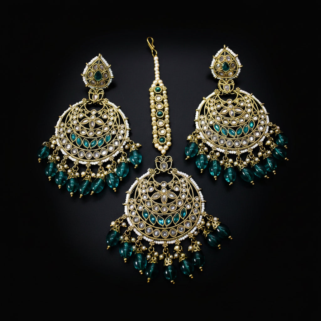 Ornate earrings with teal beads on a dark background