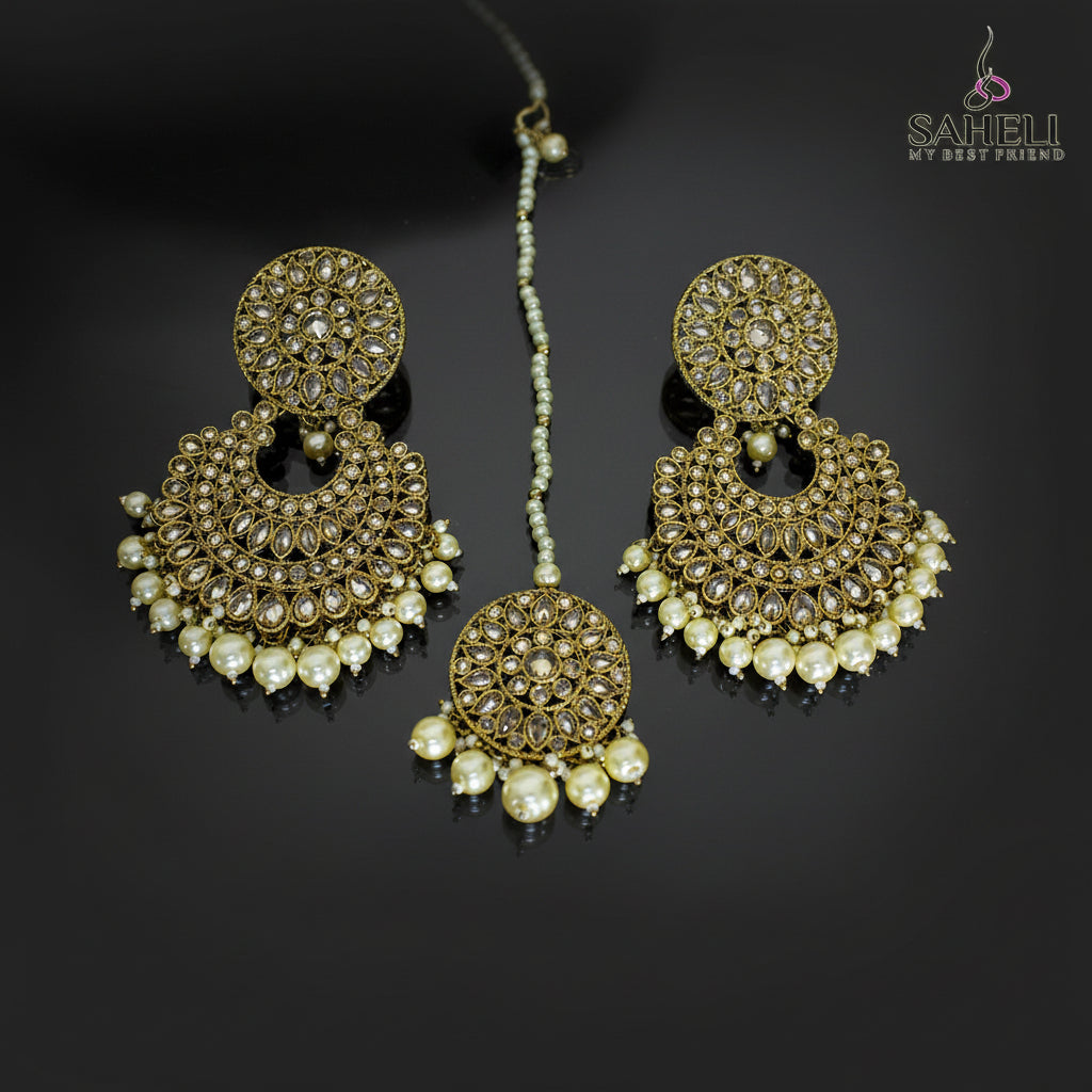 Gold and pearl earrings on a dark background with 'Saheli' branding.
