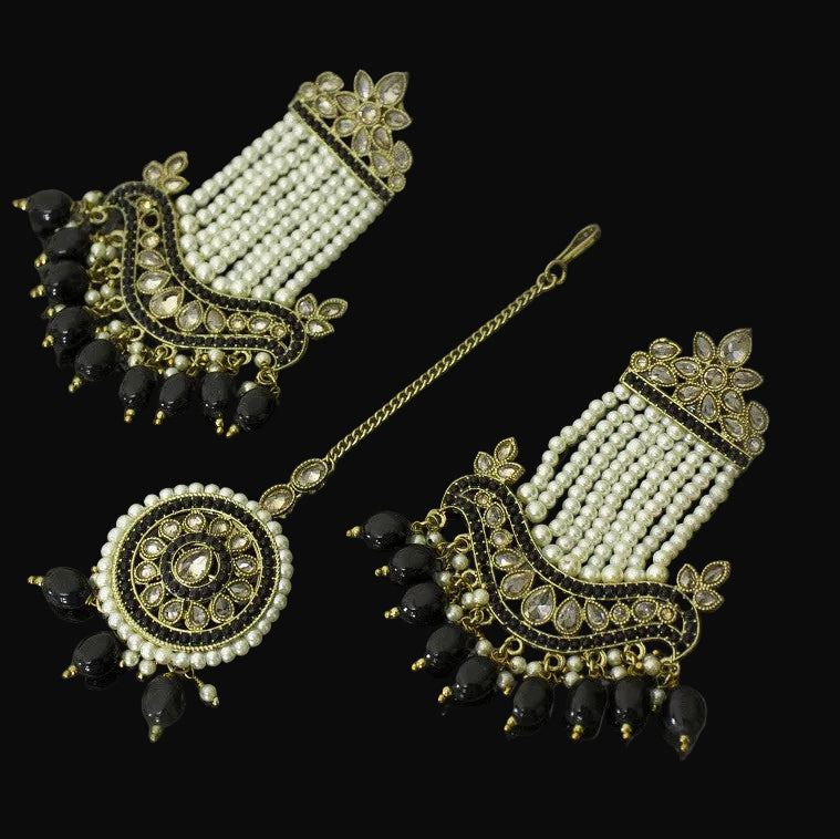 Set of traditional earrings with black and gold details on a gray background