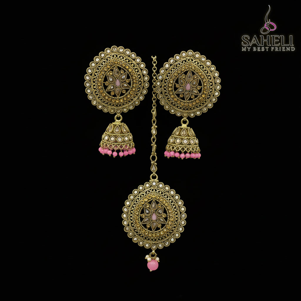 Ornate gold earrings with pink beads on a dark background, branded 'Saheli'.