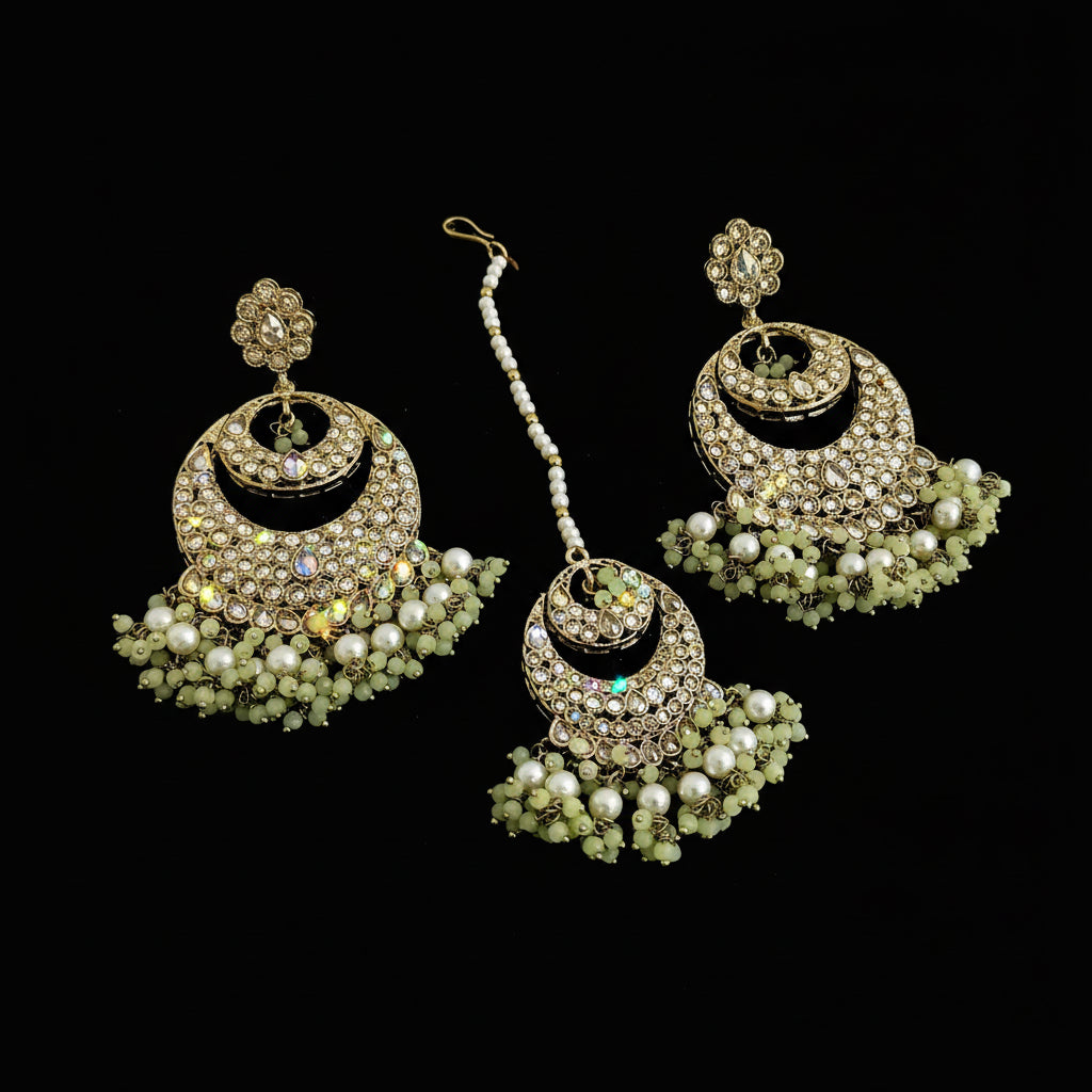 Gold and pearl jewelry set on a dark background